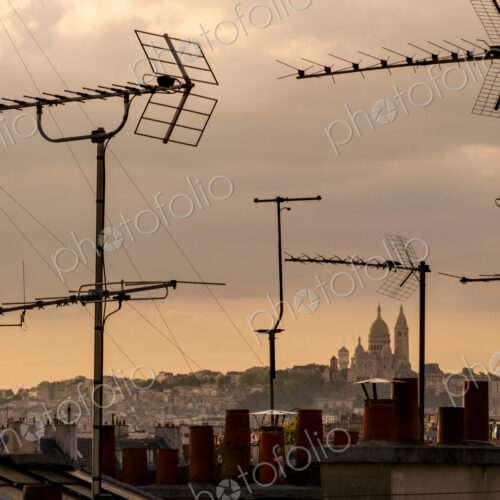 Sacré-Cur Basilica viewed through television aerial antennae and apartment rooftops.